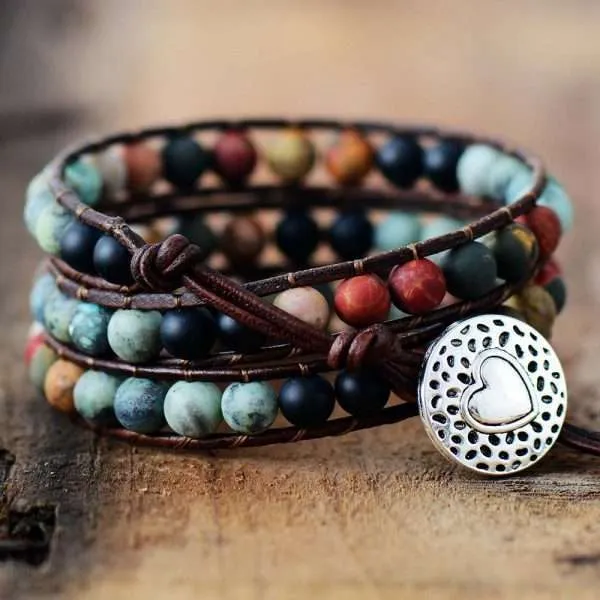 Pulsera hecha a mano de jaspe, ónix y cuerda de cuero. Medallón en forma de corazón.